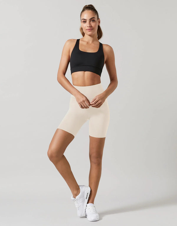 A model wearing black activeweaar shorts and a sports top