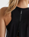 A close up of a woman wearing a black Lilybod tank top.
