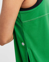 Close up of a green athletic tank top with a brand logo on a white background
