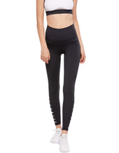 Person wearing black leggings with white text on a white background