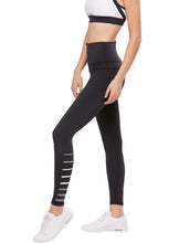 Black leggings with white stripes worn by a person on a white background