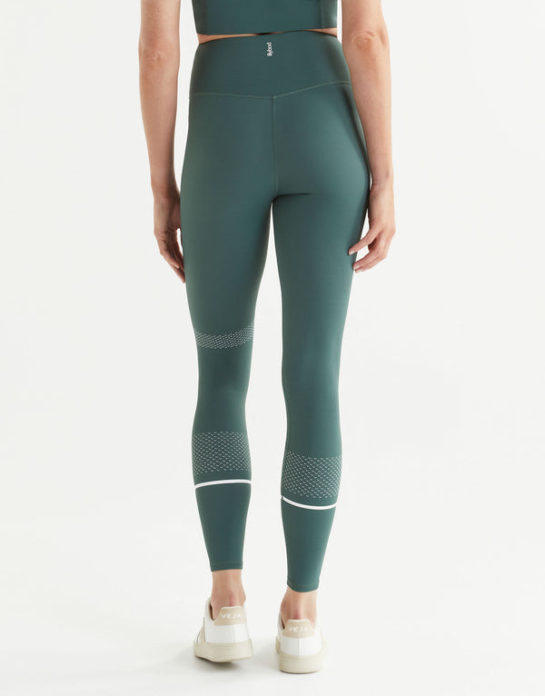 Green leggings with white accents on a white background