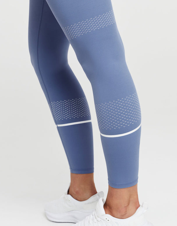 Blue leggings with white accents on a white background