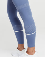 Blue leggings with white accents on a white background