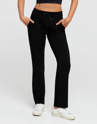 Person wearing black pants with a white background