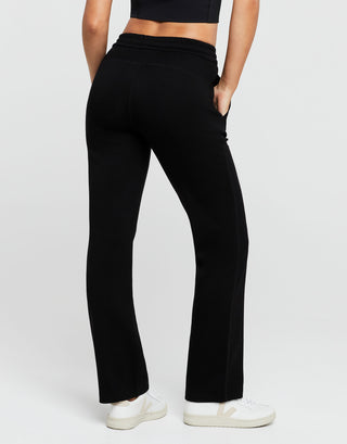 Person wearing black pants on a white background