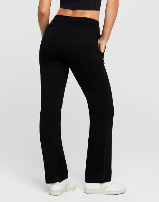 Person wearing black pants on a white background