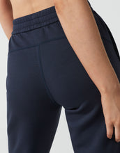 close up of dark blue sweatpants on a person