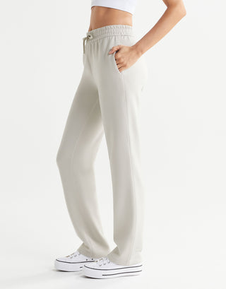 Beige sweatpants worn by a person on a white background