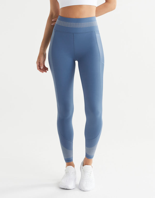 Blue leggings worn by a person on a white background