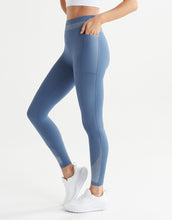 Blue leggings worn by a person on a white background