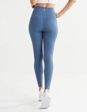 Blue leggings worn by a person on a white background