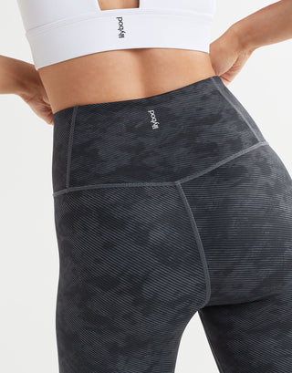 Close up of black stucco leggings on a white background
