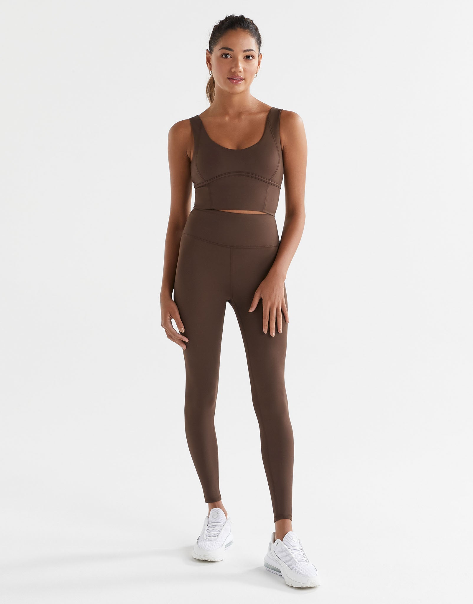 A woman wearing Lilybod Astrid Oak leggings and a matching sports bra.