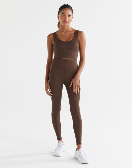 A woman wearing Lilybod Astrid Oak leggings and a matching sports bra.