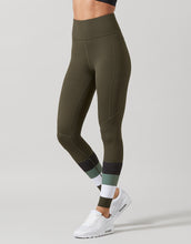 Green leggings worn by a person on a light gray background