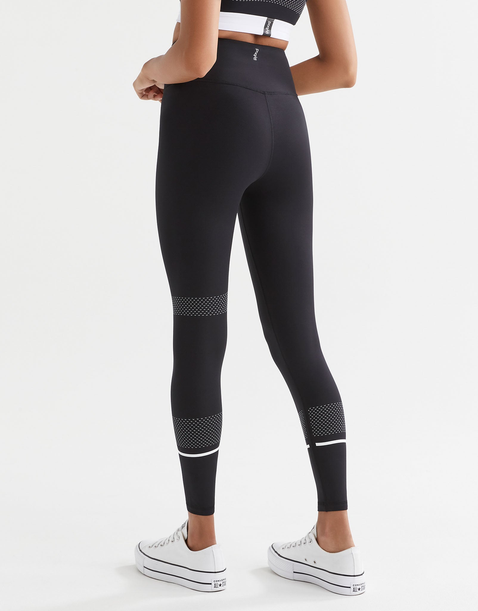 A pair of high-waisted full length leggings in black with white contrast stripes and mesh details. The brand logo 'Lilybod' is visible at the center.