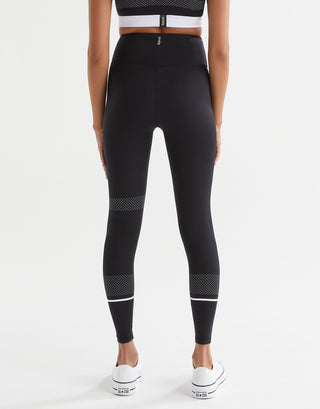 A pair of high-waisted full length leggings in black with white contrast stripes and mesh details. The brand logo 'Lilybod' is visible at the center.
