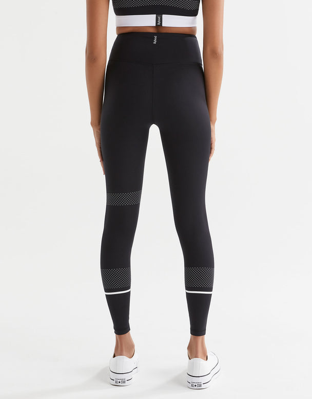 A pair of high-waisted full length leggings in black with white contrast stripes and mesh details. The brand logo 'Lilybod' is visible at the center.