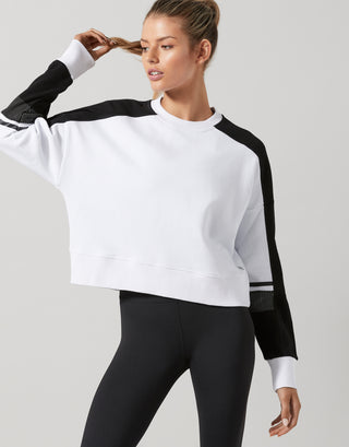 Woman wearing a white and black outfit on a light gray background