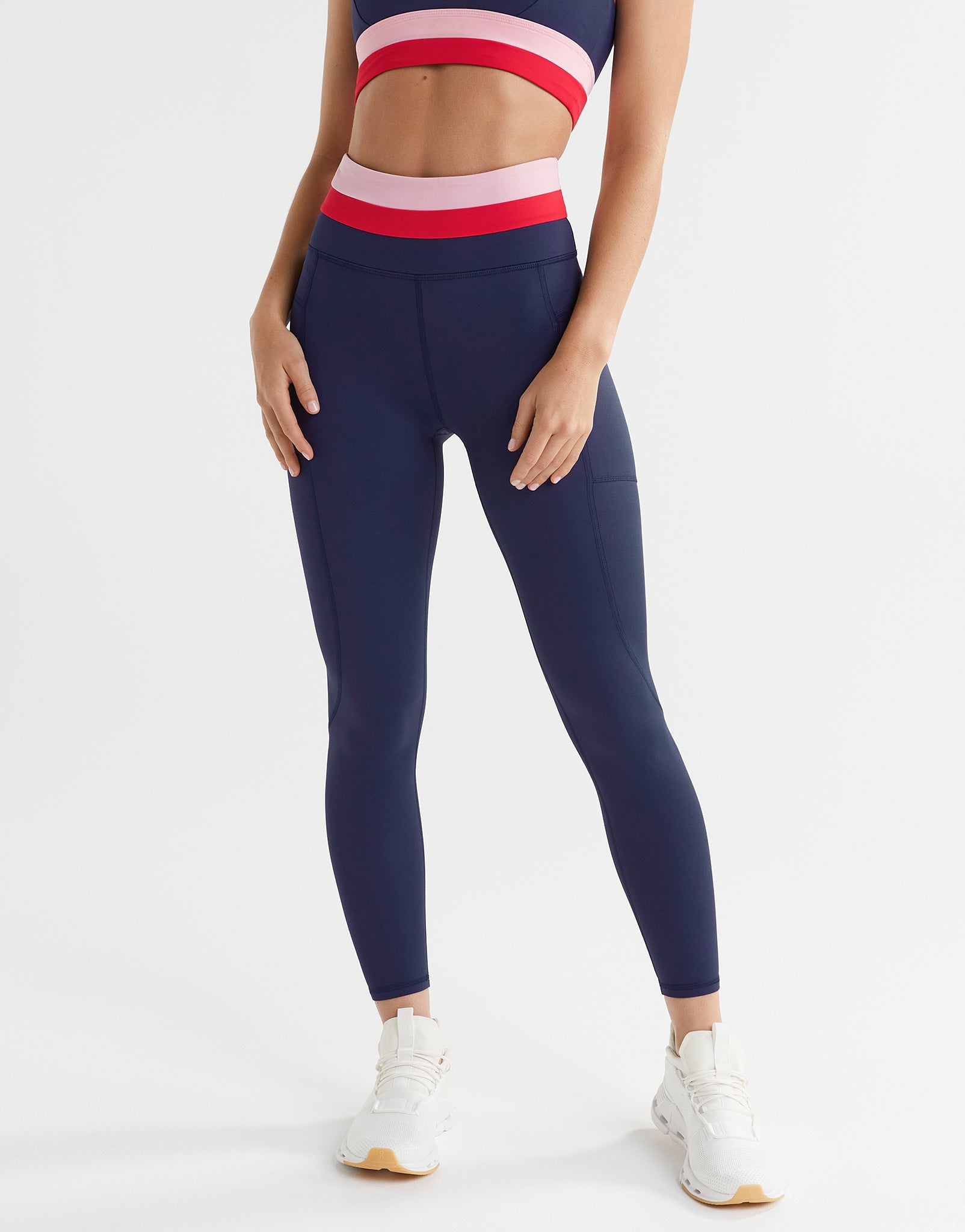 A woman wearing blue, red and pink leggings
