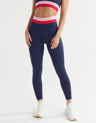 A woman wearing blue, red and pink leggings