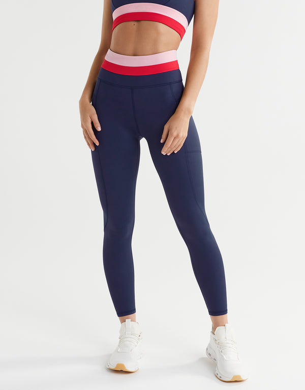 A woman wearing blue, red and pink leggings