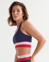 Woman wearing a sports bra with a striped design on a white background