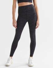 Person wearing black leggings on a white background