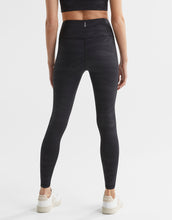Person wearing black leggings on a white background