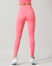 Pink leggings worn by a person on a gray background