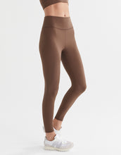 Brown leggings worn by a person on a white background