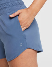 Blue shorts with a brand logo on a plain background