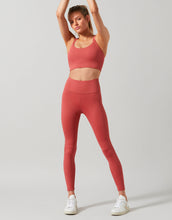 Person wearing a red athletic outfit on a light gray background