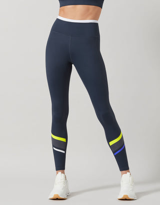 Navy leggings with colorful stripes on a gray background
