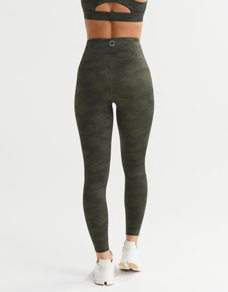 A rear view of a woman wearing green camo leggings.
