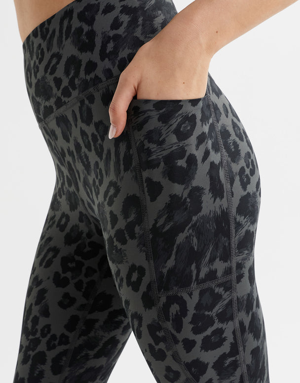 Close up of grey leopard print leggings with a pocket.