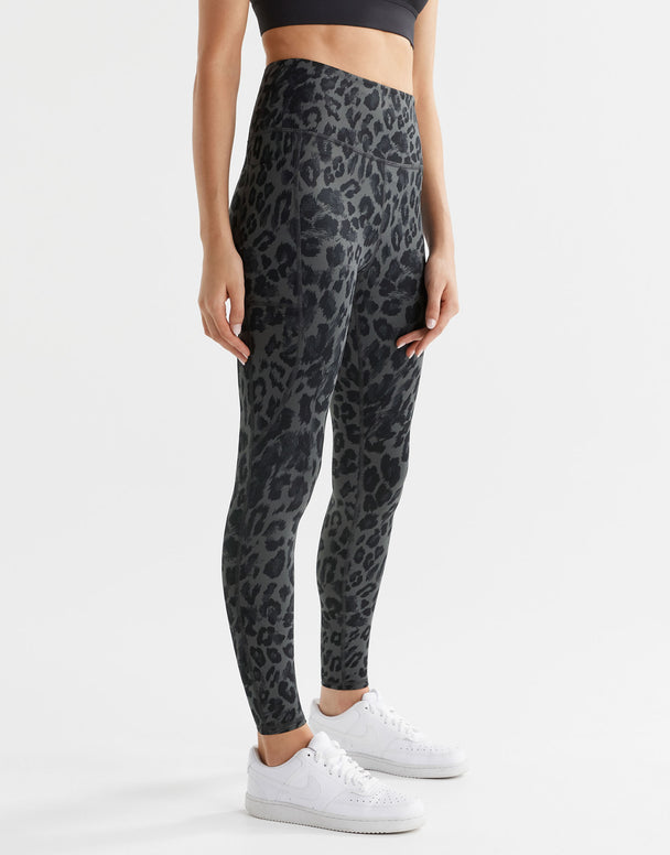 A woman wearing grey leopard print leggings.