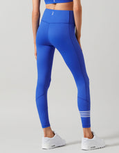Blue leggings with a white stripe on a gray background