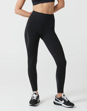 Person wearing black leggings on a white background