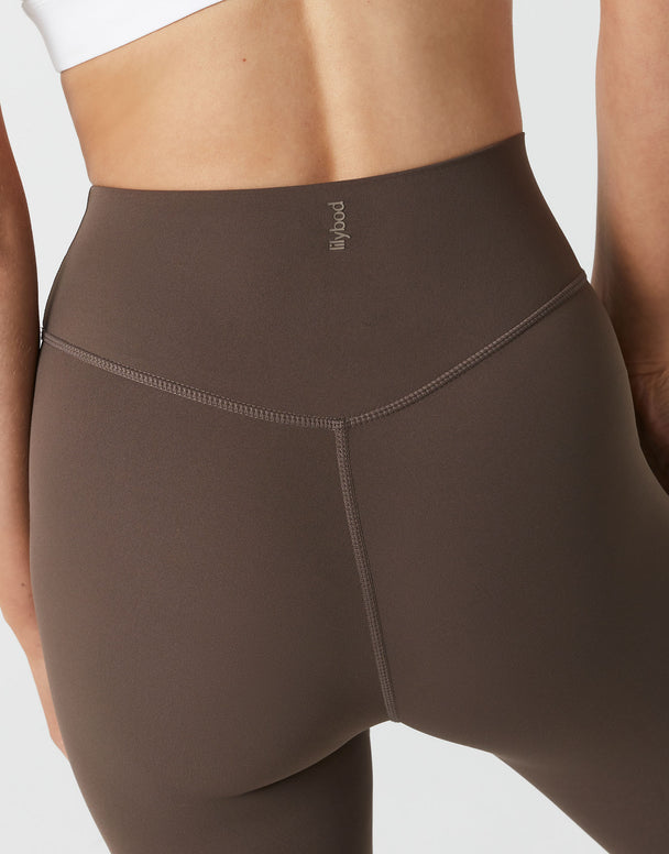 Brown leggings worn by a person on a light gray background