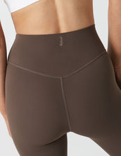 Brown leggings worn by a person on a light gray background