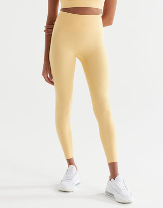A pair of high-waisted yellow leggings with a minimal seaming design, designed for activewear.