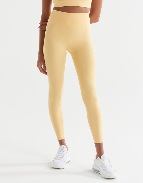 A pair of high-waisted yellow leggings with a minimal seaming design, designed for activewear.