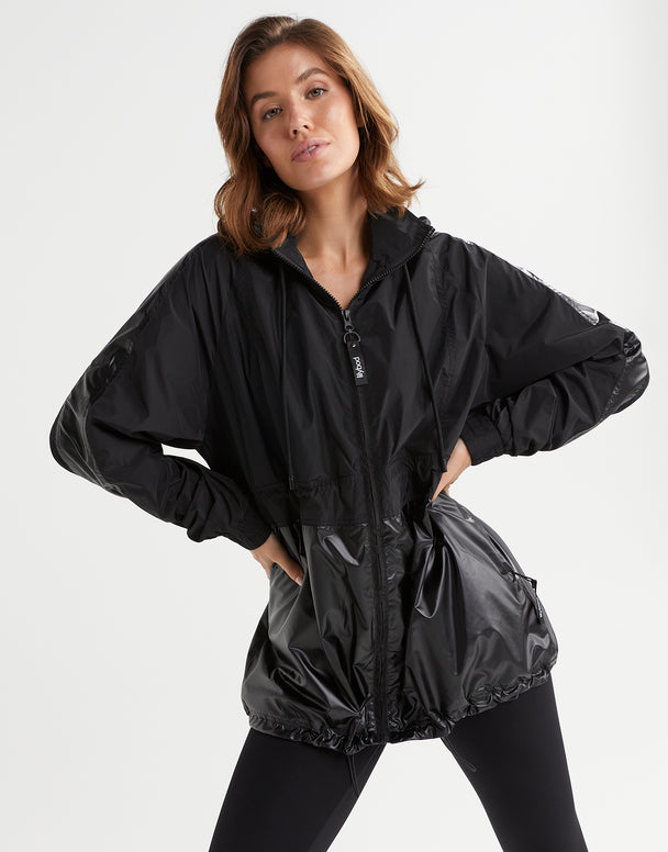 Woman wearing a black jacket with a white background