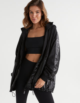 A woman wearing a black jacket and top and leggings.
