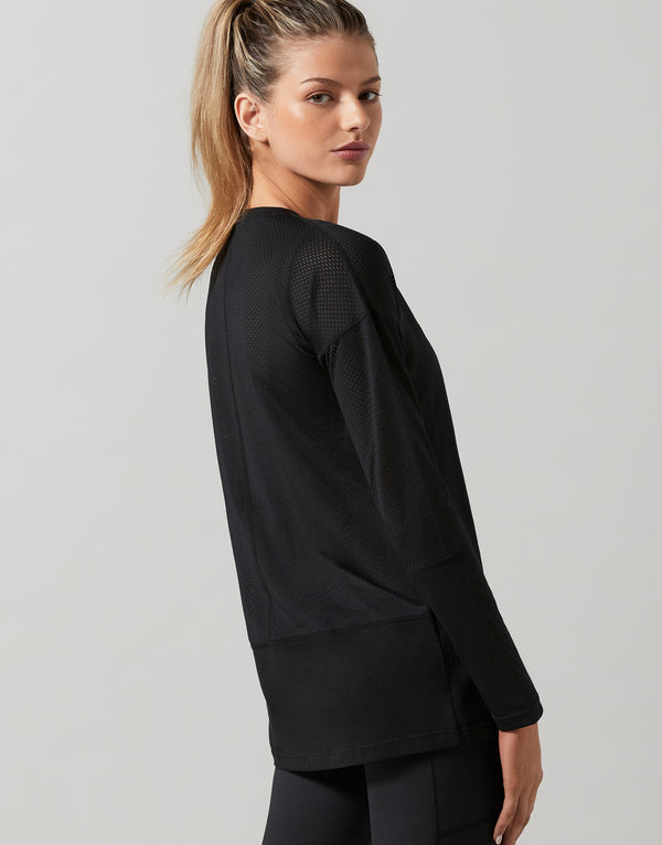 Woman wearing a black outfit on a gray background