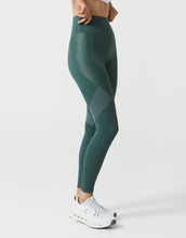 Green leggings worn by a person on a white background
