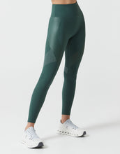 Green leggings worn by a person on a white background
