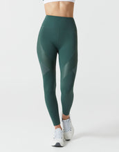 Green leggings worn by a person on a white background